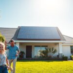 A bright and modern home, powered by the renewable energy of MSM Solar LLC's sleek solar panels. The sun's rays shine down on the rooftop, casting a warm glow over the well-manicured lawn and lush greenery. In the foreground, a happy family enjoys the benefits of clean, affordable energy, with a sense of pride and environmental responsibility. The middle ground showcases the efficient, low-profile solar installation, seamlessly integrated into the home's architecture. The background features a clear, blue sky, symbolizing the limitless potential of sustainable energy solutions. This image captures the essence of Navarre Solar Panels: a local, reliable, and cost-effective energy solution for homeowners.