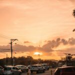 Cars driving at sunset in Panama City, showcasing urban landscape and tropical atmosphere.