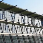 Contemporary office building featuring glass facade and unique architectural design, reflecting modern industry innovation.