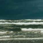 Captivating view of a stormy sea under dark clouds, showcasing powerful ocean waves.