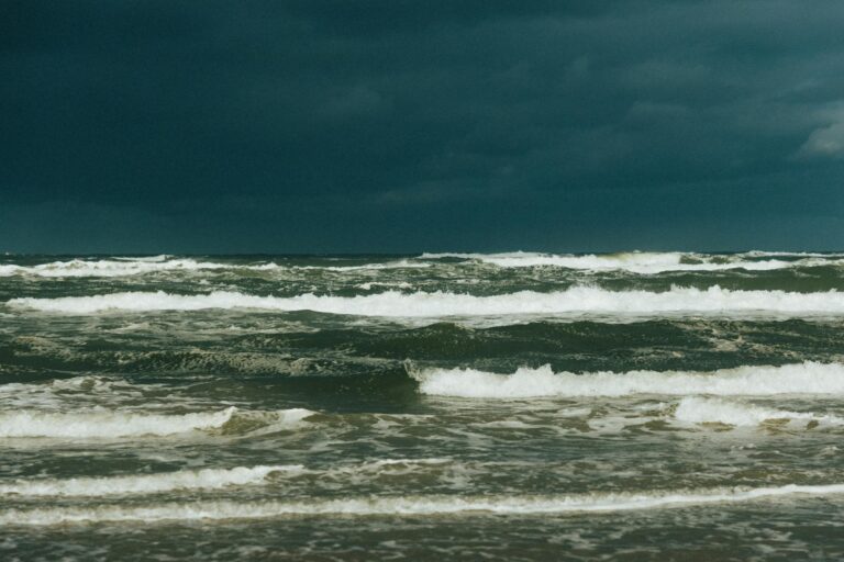 Captivating view of a stormy sea under dark clouds, showcasing powerful ocean waves.
