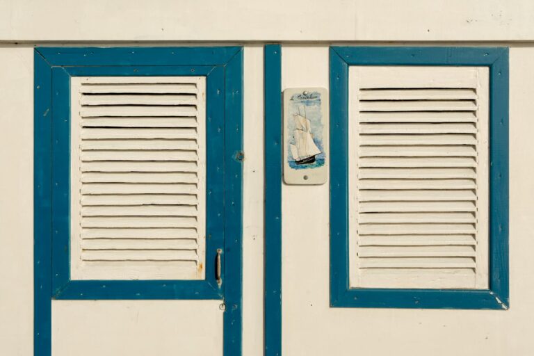 Close-up of a nautical-themed blue and white beach cottage facade.