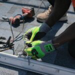 Technician installing solar panels on a roof in Tampa, showcasing clean energy efforts.