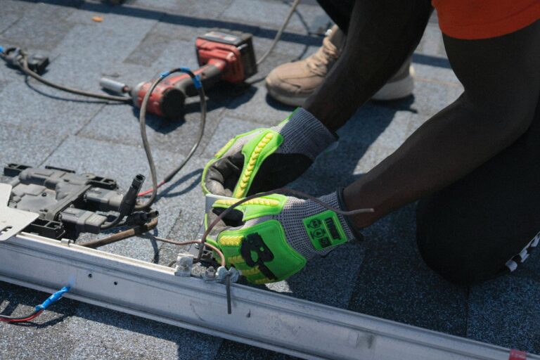 Technician installing solar panels on a roof in Tampa, showcasing clean energy efforts.