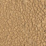 High resolution texture of cracked dry earth typically found in arid environments.