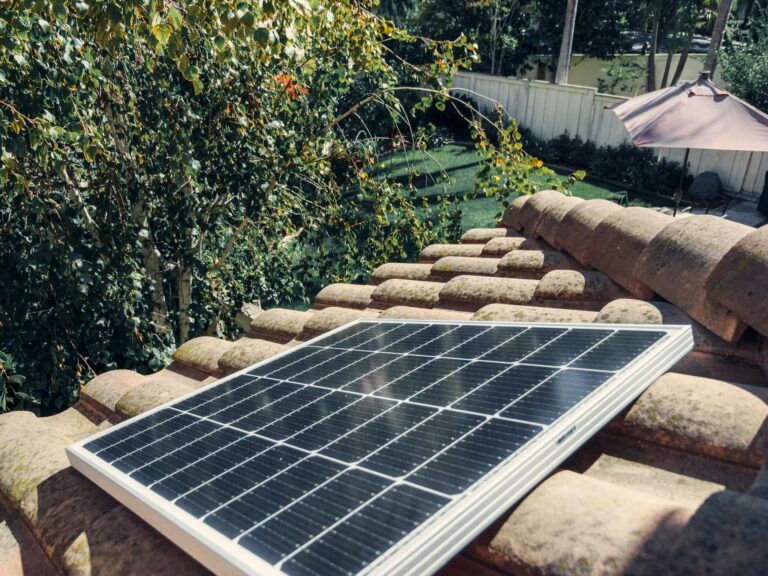 Close-up of a solar panel installed on a tiled roof, capturing clean energy.