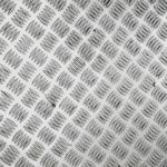 Close-up view of a silver metallic tread plate with a repeating checkered pattern.