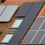 Close-up of solar panels on a tiled roof, showcasing sustainable energy solutions.