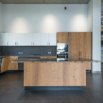 Interior of contemporary kitchen with white and brown cabinets and wooden table in minimalist style