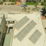 Aerial shot of solar panels on a rooftop in Karachi, highlighting sustainable energy solutions in urban settings.