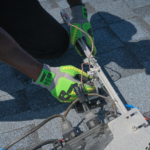 Close-up of a technician working on solar panel installation with green gloves in Tampa, Florida.