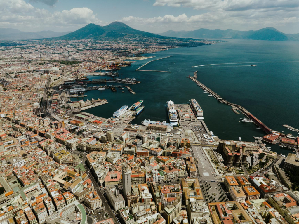 Stunning aerial view of Naples harbor with iconic Mount Vesuvius in the background.