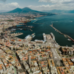 Stunning aerial view of Naples harbor with iconic Mount Vesuvius in the background.
