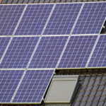 Close-up view of solar panels on a tiled rooftop, capturing clean energy.