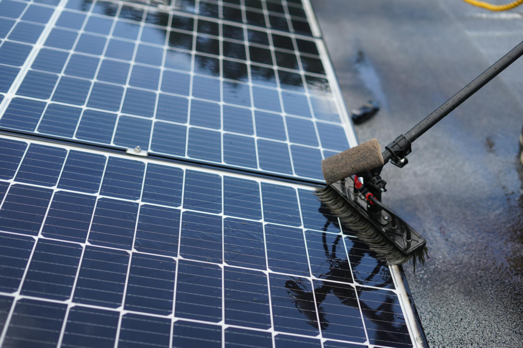 Close-up of solar panel cleaning using a brush tool in Tampa, Florida.