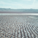 Aerial view of a vast solar farm in a desert setting, capturing renewable energy technology.