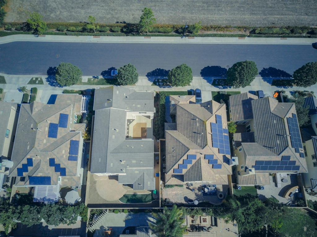Aerial shot showcasing suburban homes equipped with solar panels for renewable energy.