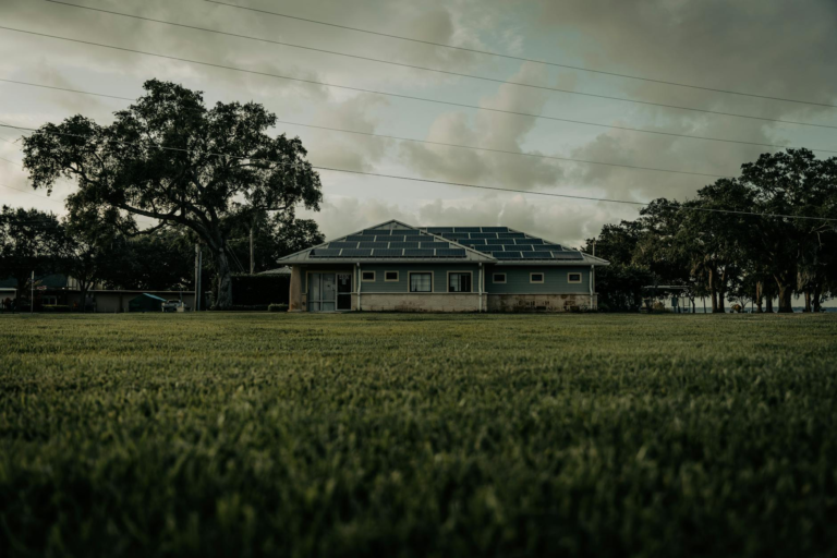 A sustainable home with solar panels in a lush Florida setting, showcasing green energy.