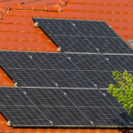 Close-up of solar panels on a red tiled roof in Croatia, highlighting renewable energy.