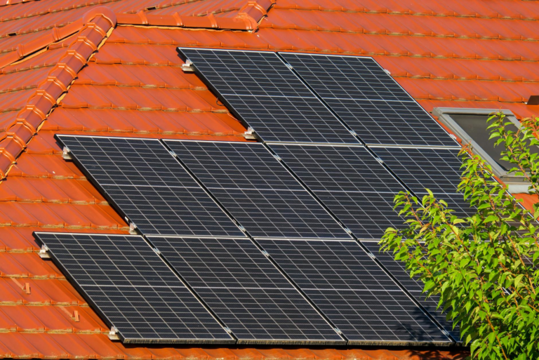 Close-up of solar panels on a red tiled roof in Croatia, highlighting renewable energy.
