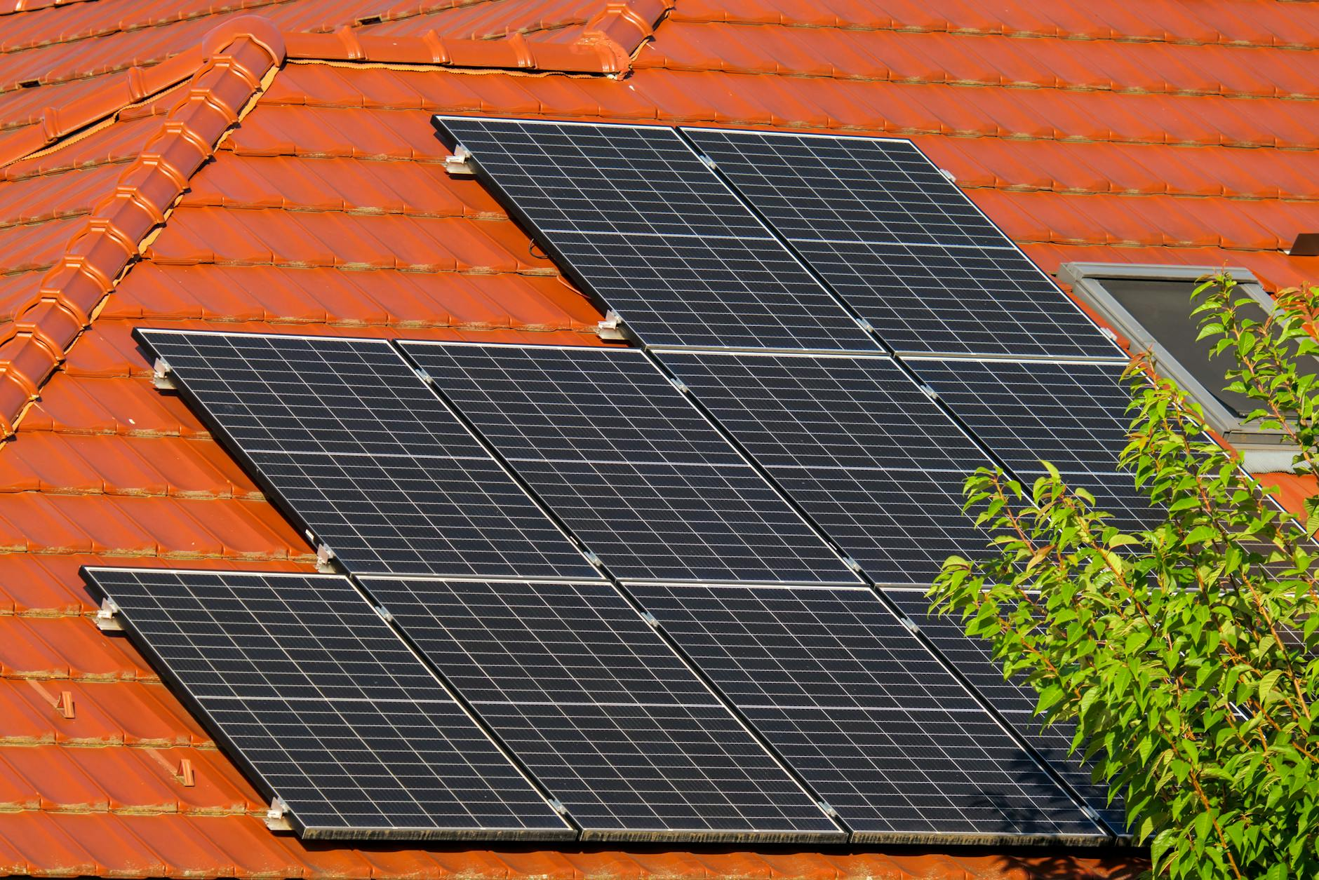 Close-up of solar panels on a red tiled roof in Croatia, highlighting renewable energy.