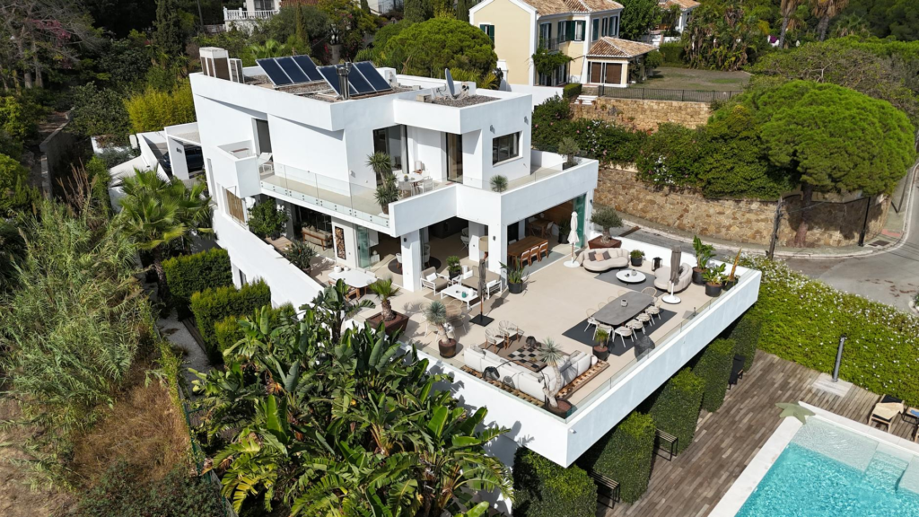 Aerial shot of a modern luxury villa with a spacious terrace and pool.