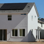 Newly constructed eco-friendly home in Elk Grove, CA, featuring rooftop solar panels for sustainable energy.