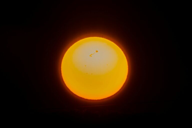 Close-up view of the sun showcasing solar flares and sunspots, captured in a cosmic setting.