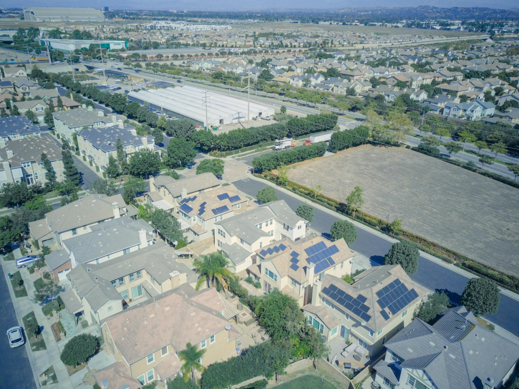 Aerial shot showcasing solar panels on suburban houses highlighting sustainable technology.