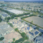 Aerial shot showcasing solar panels on suburban houses highlighting sustainable technology.