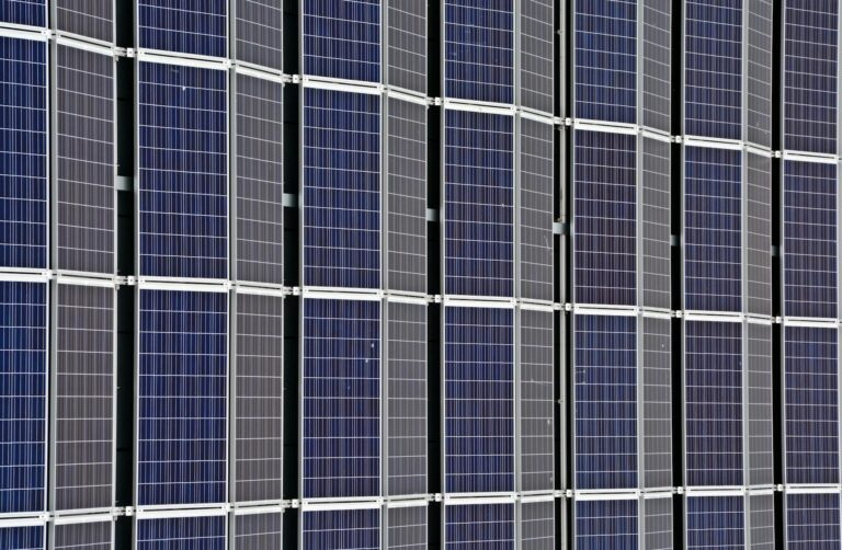 Close-up of multiple solar panels representing renewable energy and sustainability.