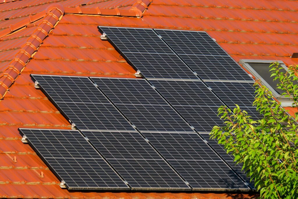 Close-up of solar panels on a red tiled roof in Croatia, highlighting renewable energy.