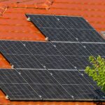 Close-up of solar panels on a red tiled roof in Croatia, highlighting renewable energy.