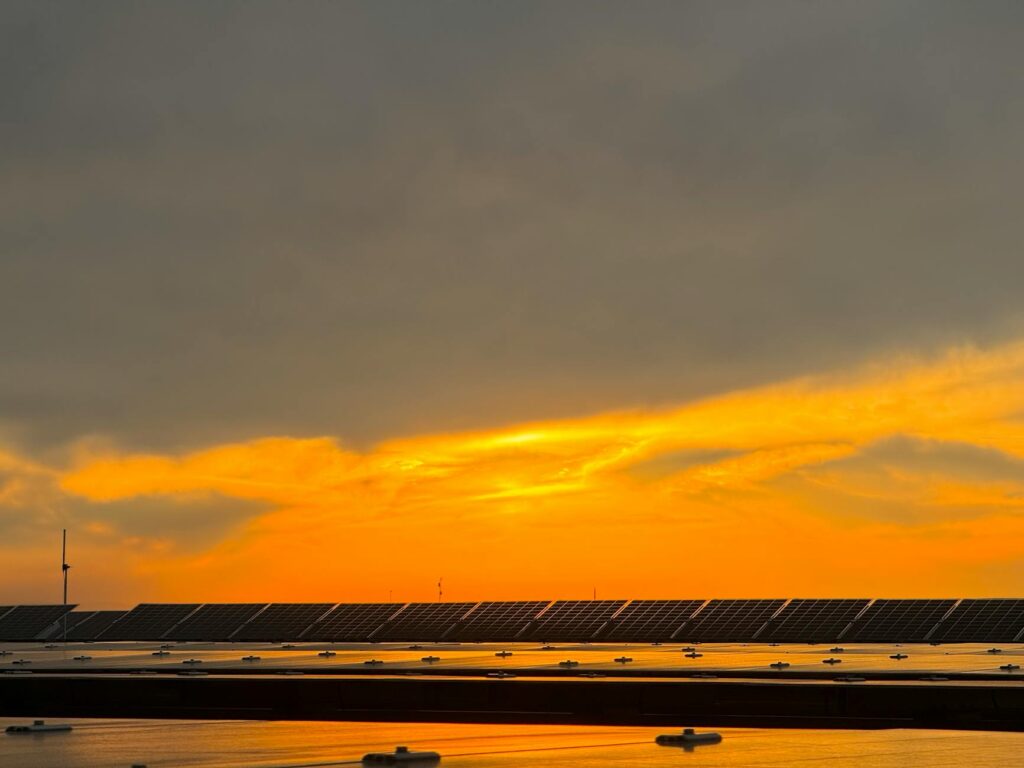 Captivating view of solar panels beneath a vibrant sunset sky in Niğde, Türkiye.