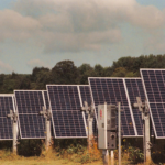Solar panels in a field generating clean, renewable energy on a sunny day.