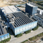 Industrial buildings with solar panels, aerial view showcasing renewable energy.
