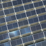 Array of solar panels in grid layout viewed from above promoting renewable energy
