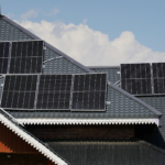 Rooftop solar panels on a house in Srinagar against a blue sky backdrop.