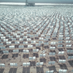 Aerial view of expansive solar panel array in a desert landscape generating renewable energy.