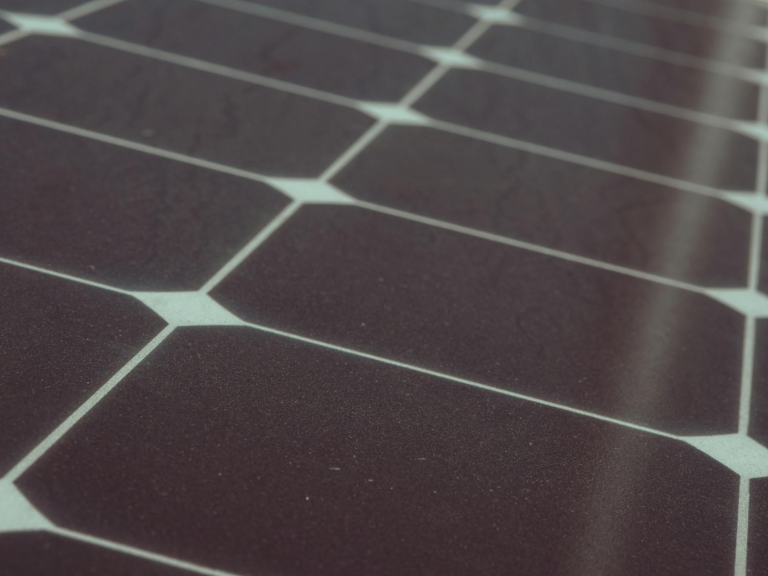 Detailed view of solar panel cells for alternative energy generation and innovation in technology.