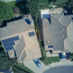 Top view of houses with solar panels, showcasing clean energy and sustainability.