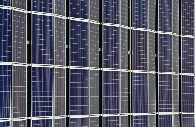 Close-up of multiple solar panels representing renewable energy and sustainability.