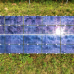 Top view of sustainable energy solar panels on a grassy field in Minnesota.