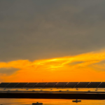 Captivating view of solar panels beneath a vibrant sunset sky in Niğde, Türkiye.