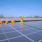 Workers install solar panels on a rooftop, promoting renewable energy and sustainability.