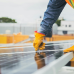 A solar technician performing maintenance on solar panels outdoors.