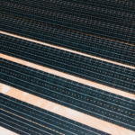 Aerial shot showcasing rows of solar panels harnessing alternative energy efficiently.