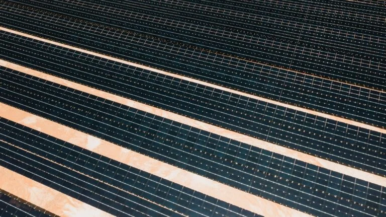 Aerial shot showcasing rows of solar panels harnessing alternative energy efficiently.