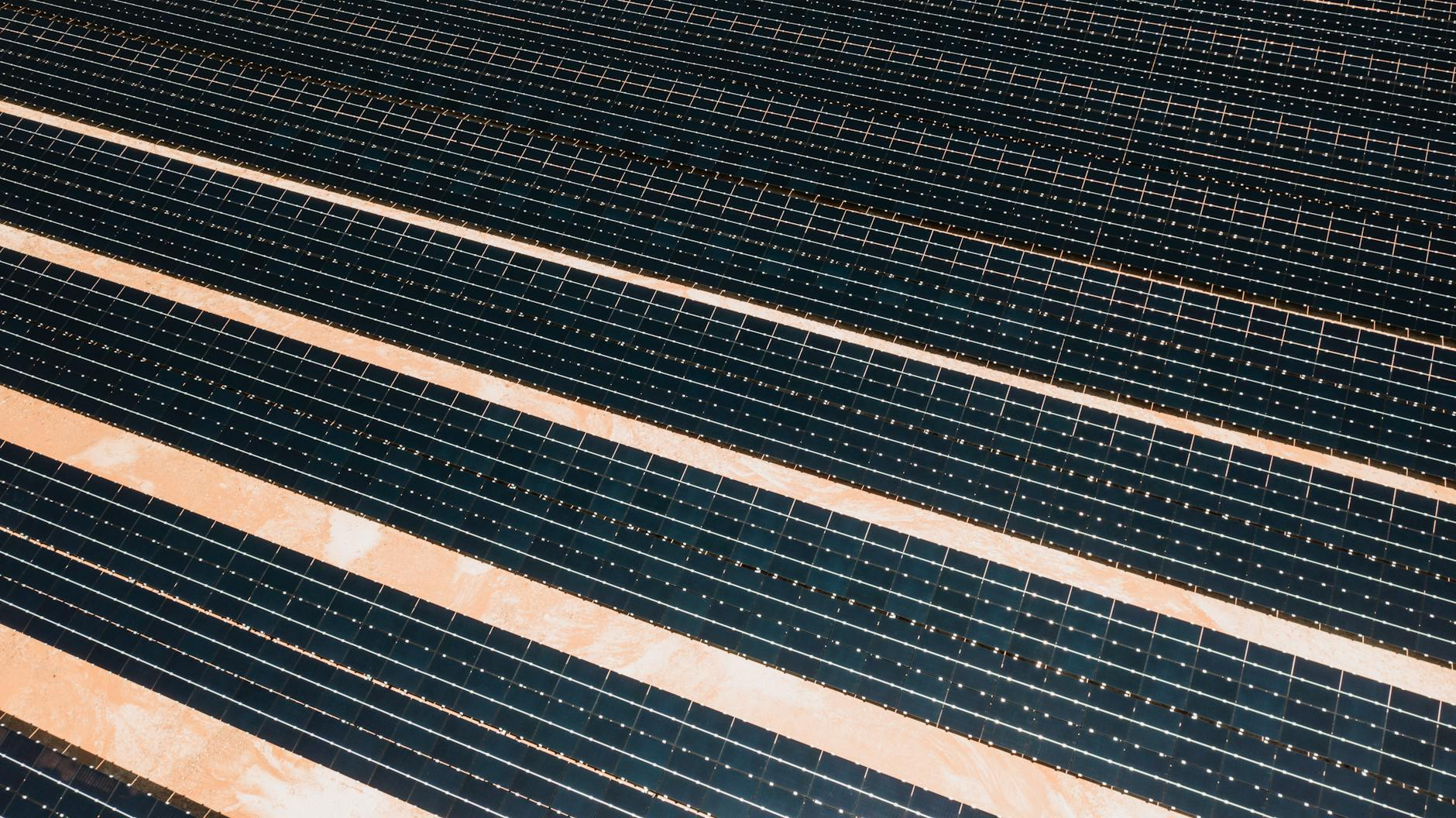 Aerial shot showcasing rows of solar panels harnessing alternative energy efficiently.