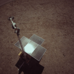 Drone view of solar panels on a dry and barren landscape emphasizing renewable energy.